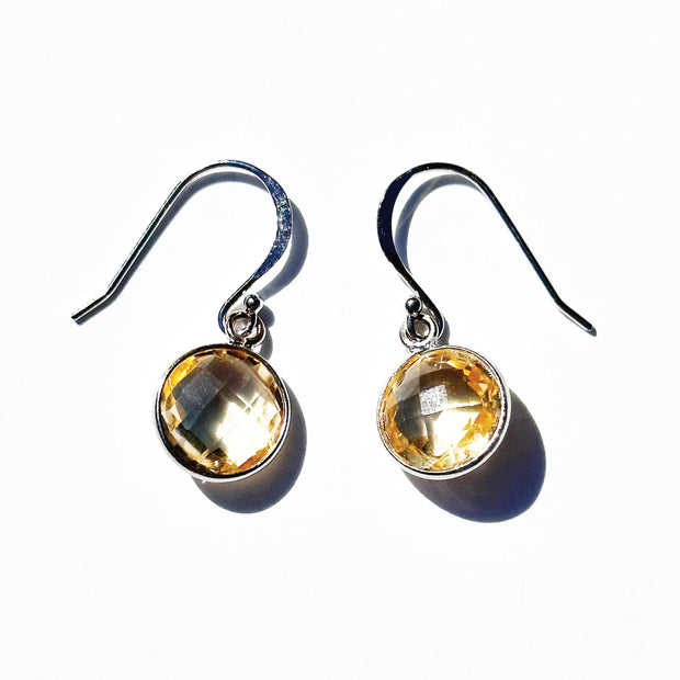 The premium round jewelry features two sparkling yellow-orange citrine gems