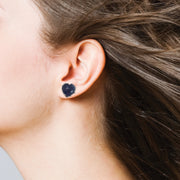 women wearing heart stud earrings