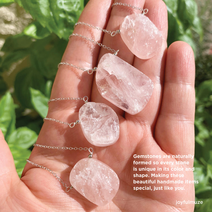 rose quartz necklace in hand